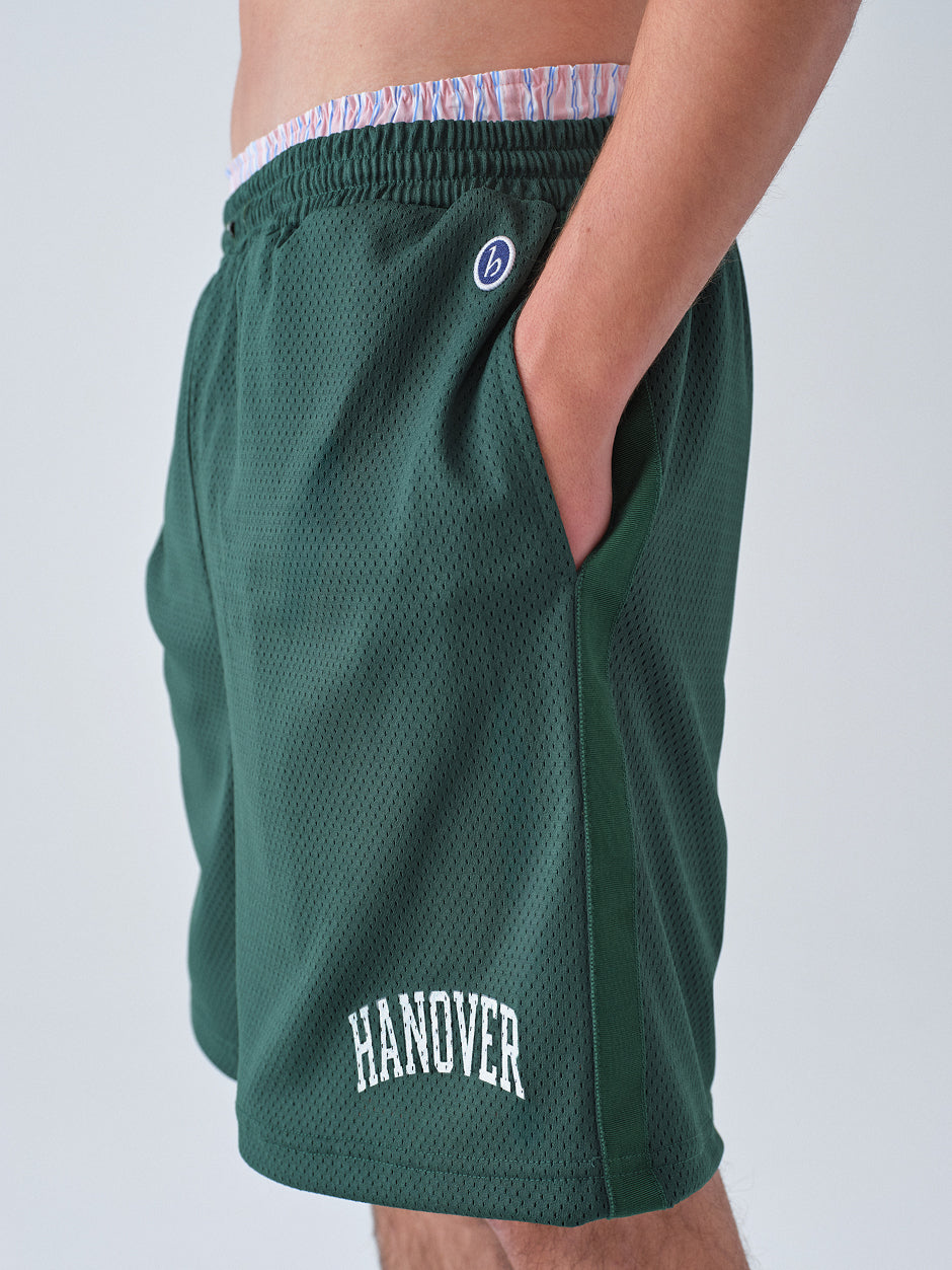 Green athletic shorts with 'Hanover' text on a plain background