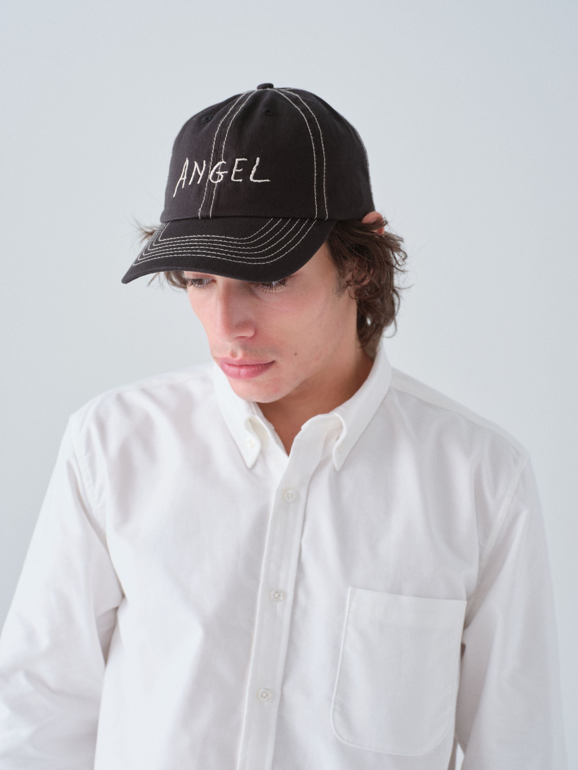 Hanover Angel contrast stitch hat on model with 'Angel' embroidery 