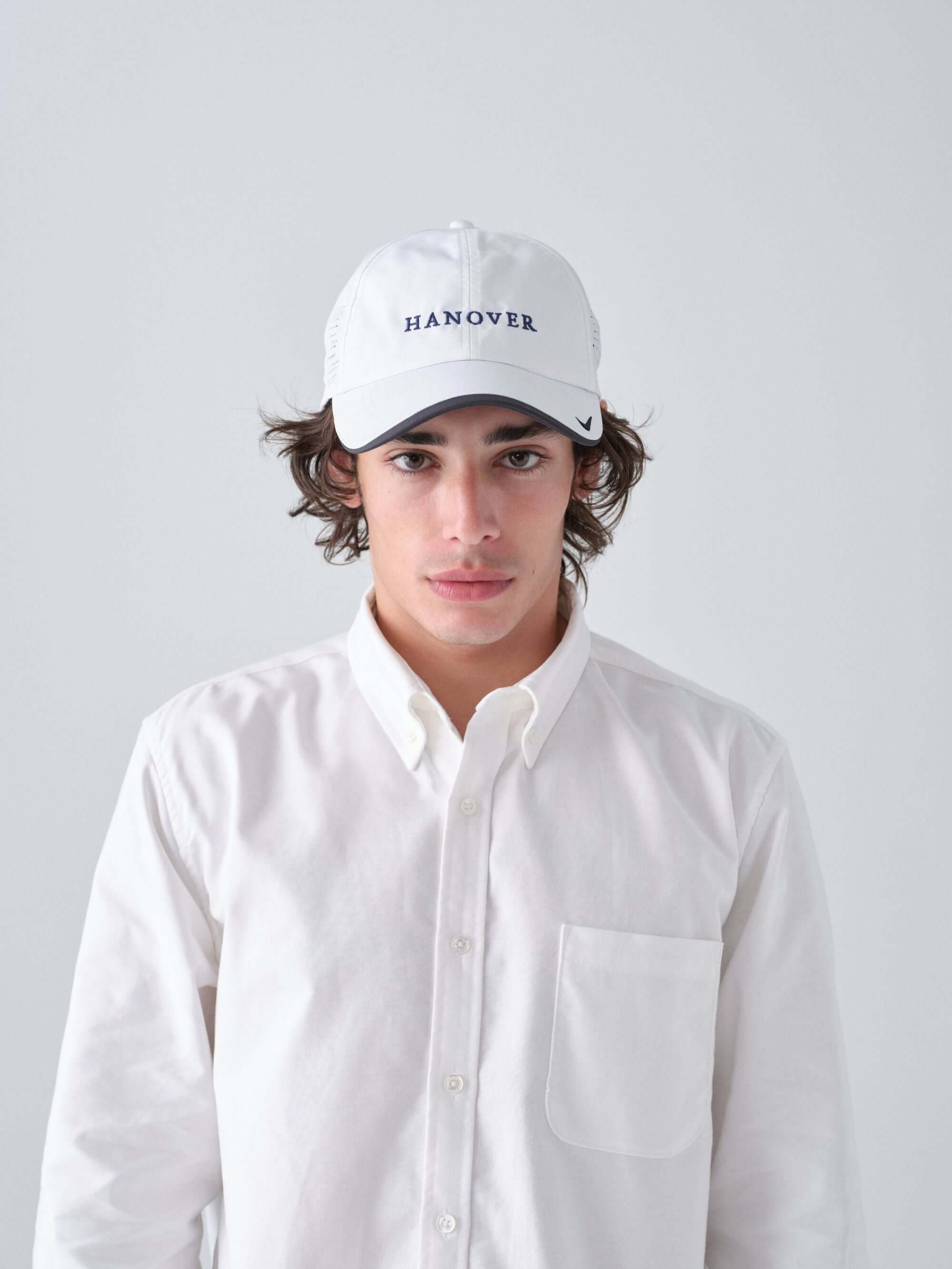 Hanover Performance hat in white on model with 'Hanover' embroidery