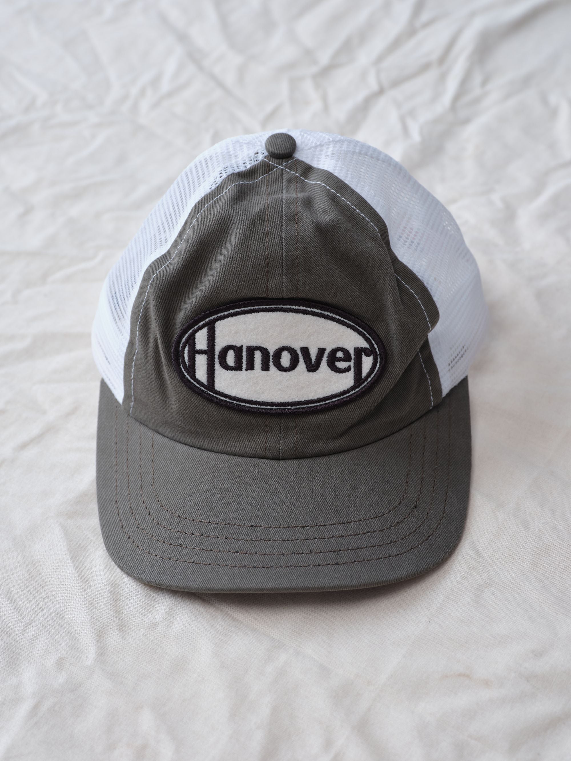 Hanover Trucker Hat flat lay textured background