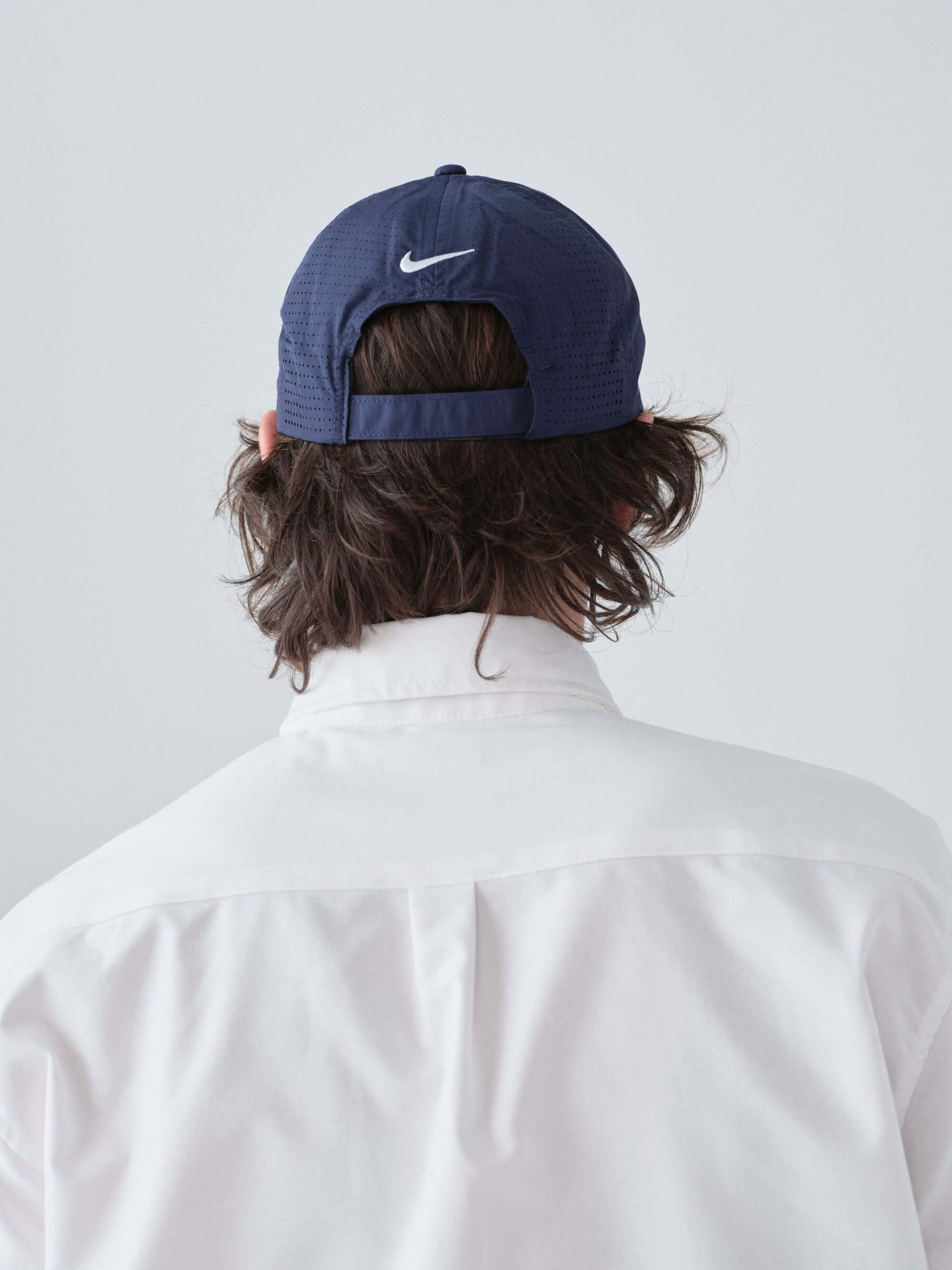 Hanover Performance hat in navy on model with 'Hanover' embroidery back view