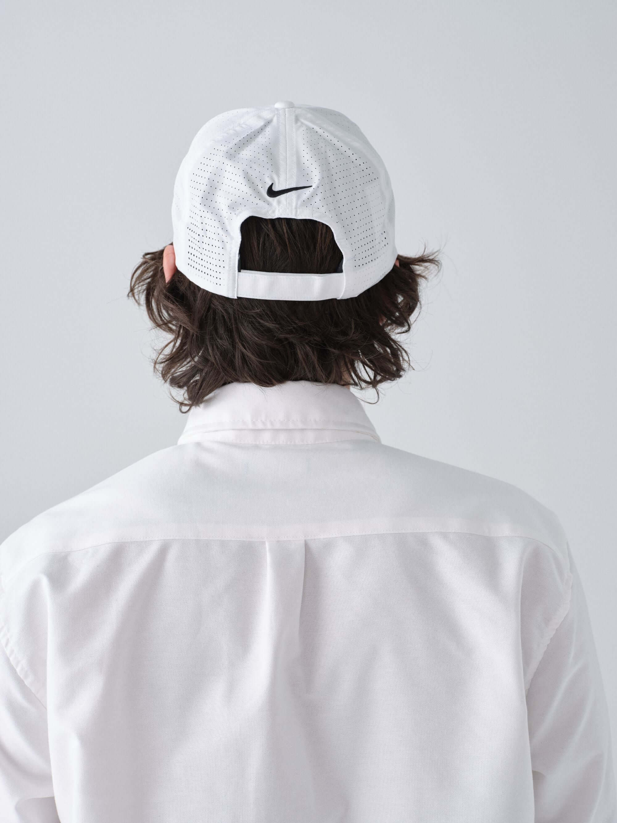 Hanover Performance hat in white on model with 'Hanover' embroidery back view