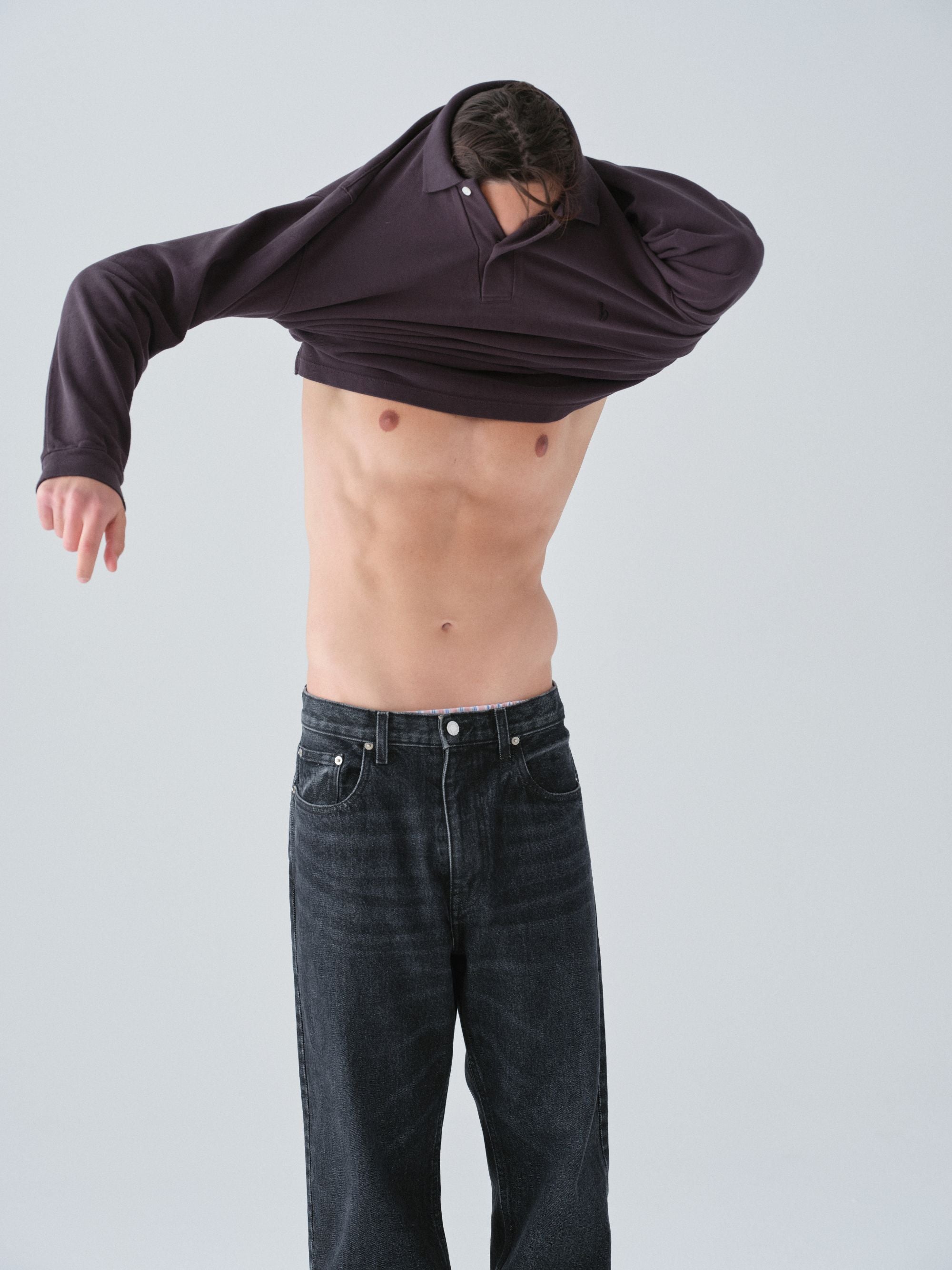 Hanover Model putting polo long sleeve shirt on demonstration