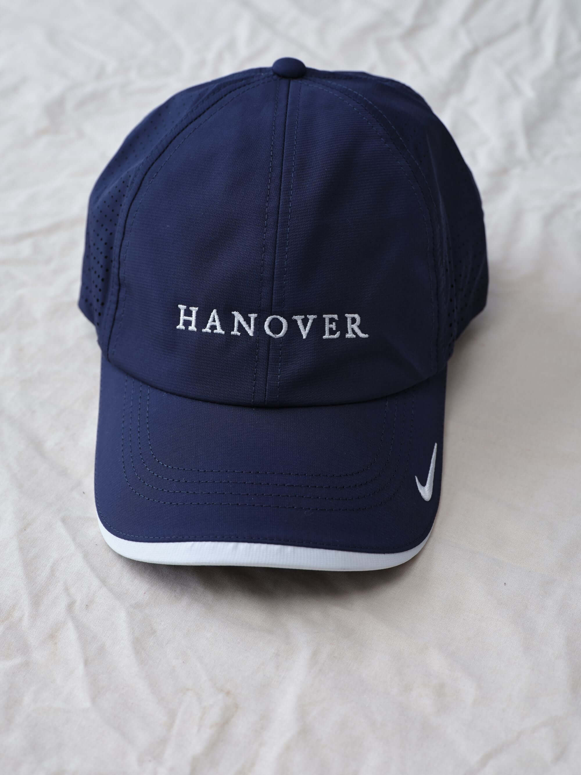 Hanover Performance Navy hat  with 'Hanover' embroidery on a white textured background