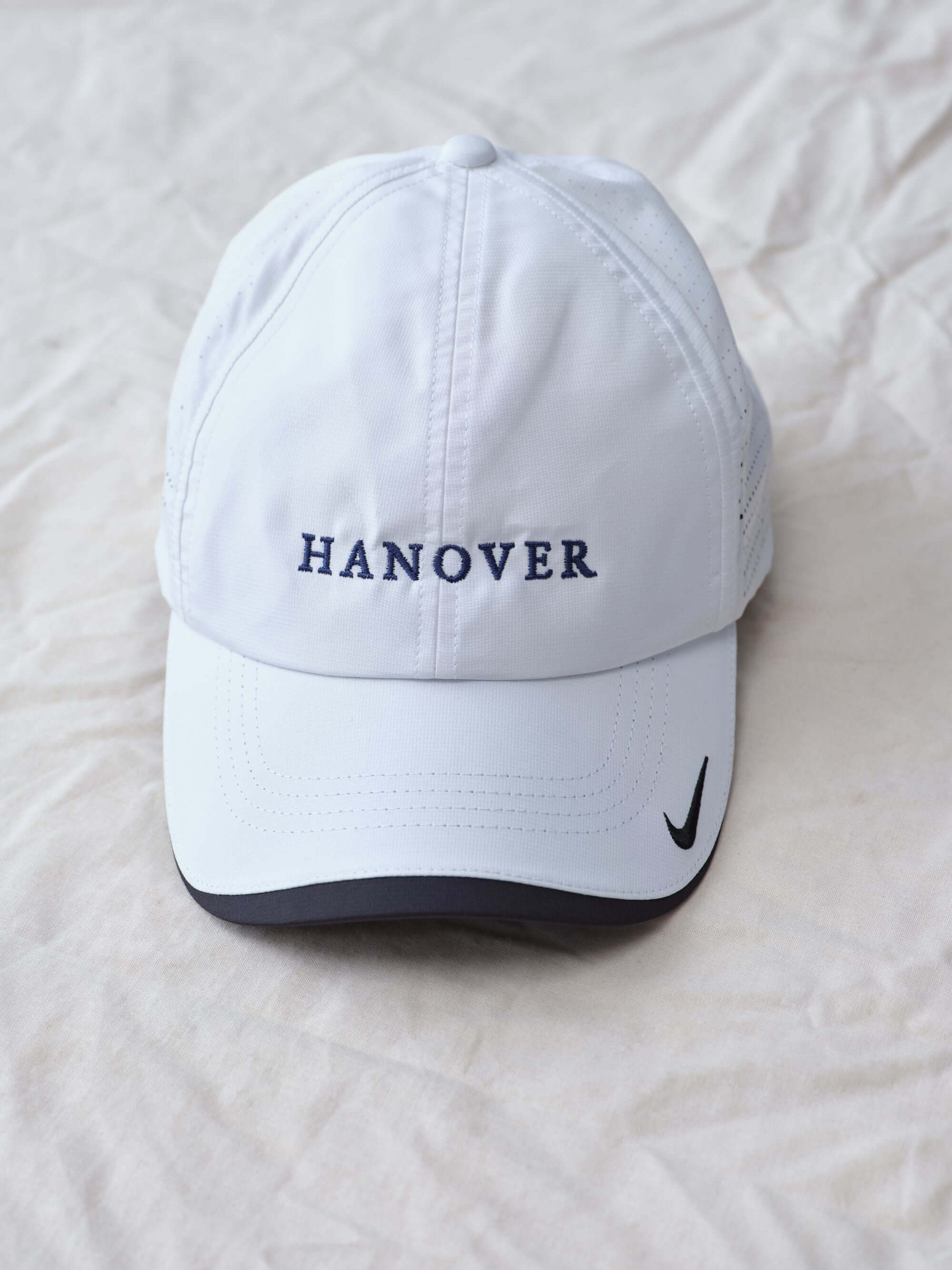Hanover Performance hat in white with 'Hanover' embroidery on a white textured background