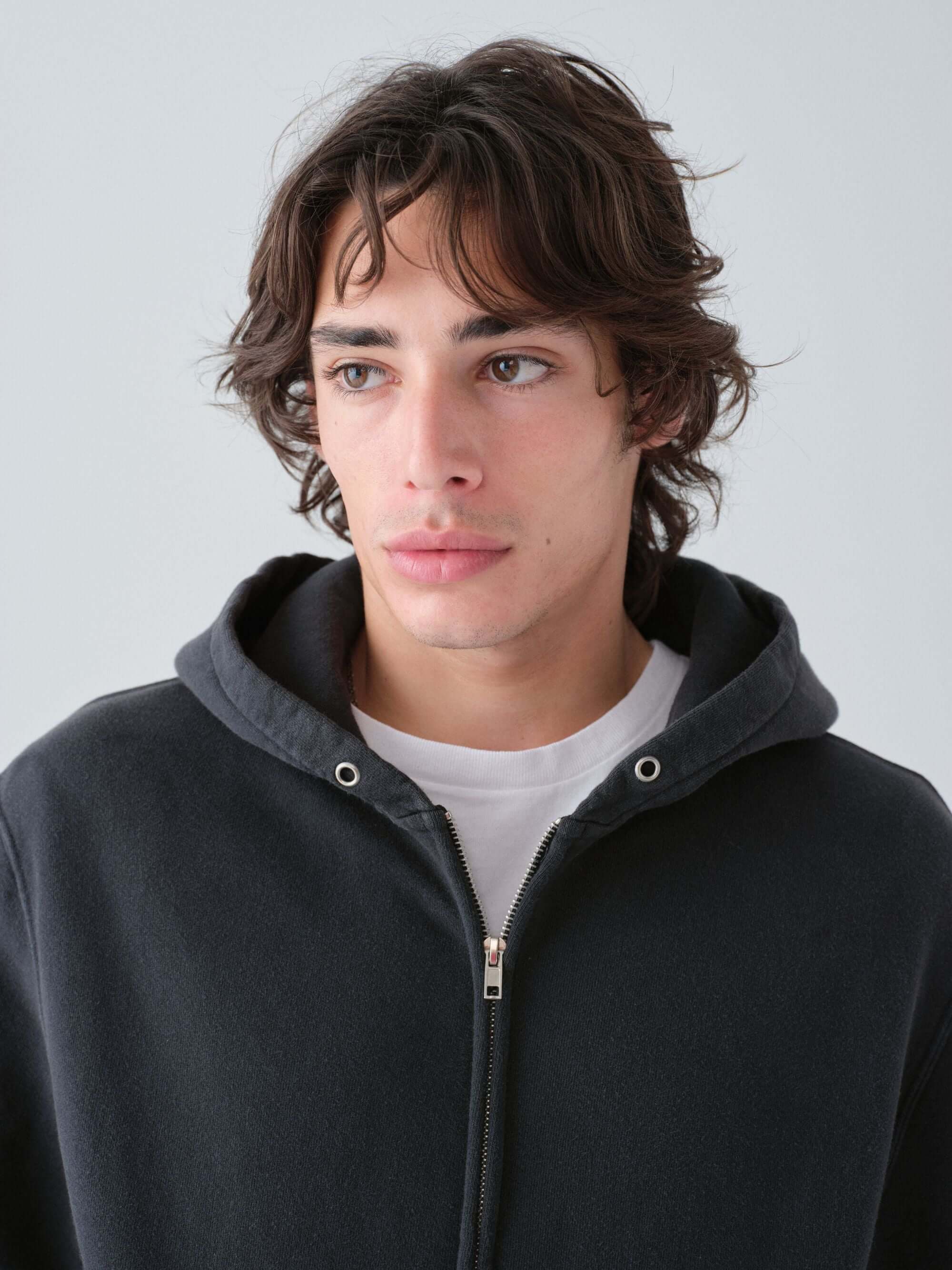 Close-up of a person wearing a HAnover zip hoodie in vintage black alternative view