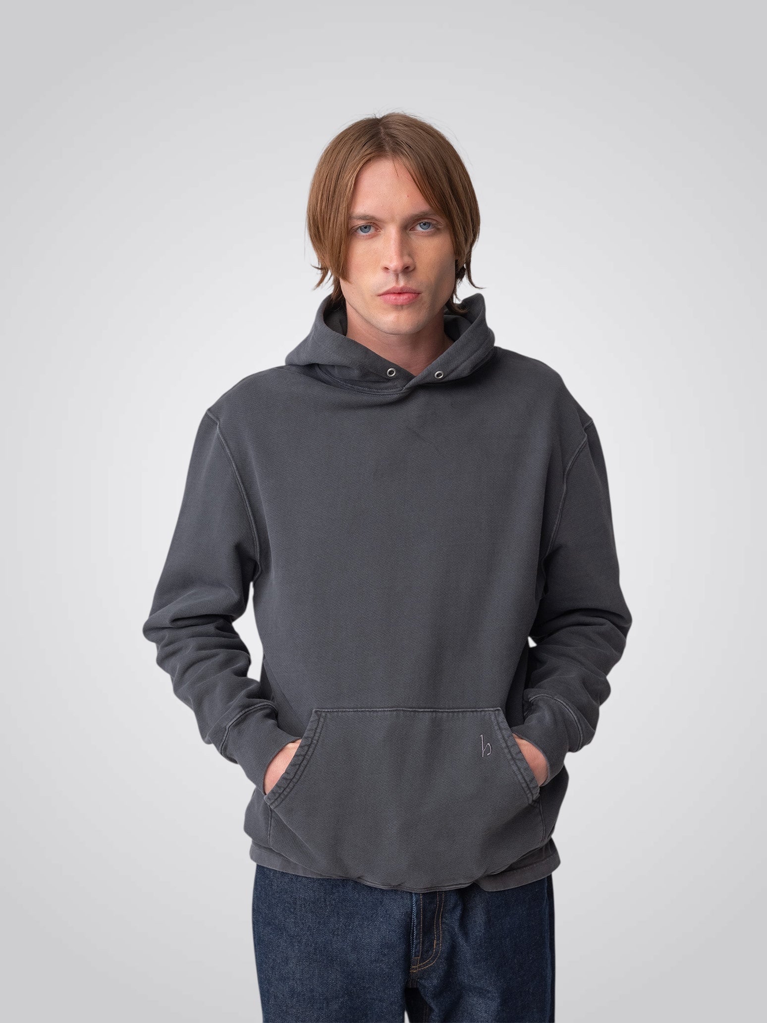 Model wearing Sunwashed Staple Hoodie in charcoal