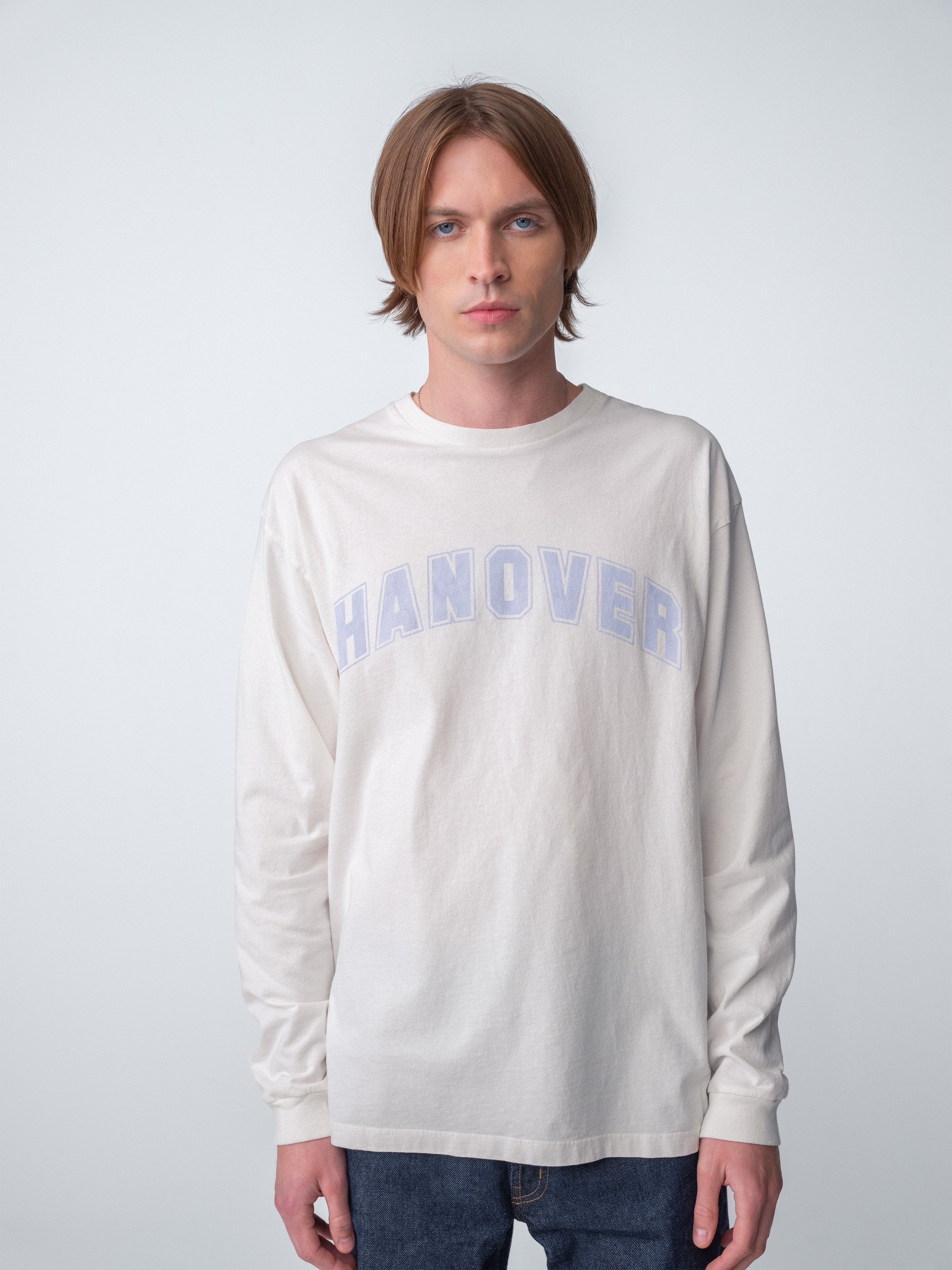 Hanover Long Sleeve Tee in faded light purple graphic on natural washed white cotton, model wearing it.