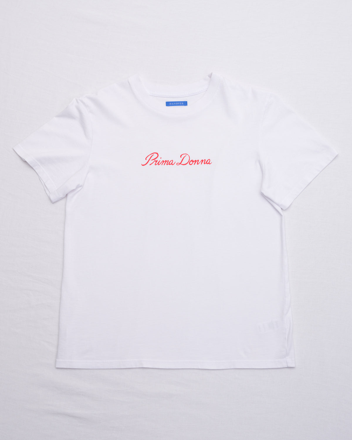 A white short-sleeve crewneck t-shirt with 'Puma Donna' printed in red cursive across the chest, laid flat on a white background.