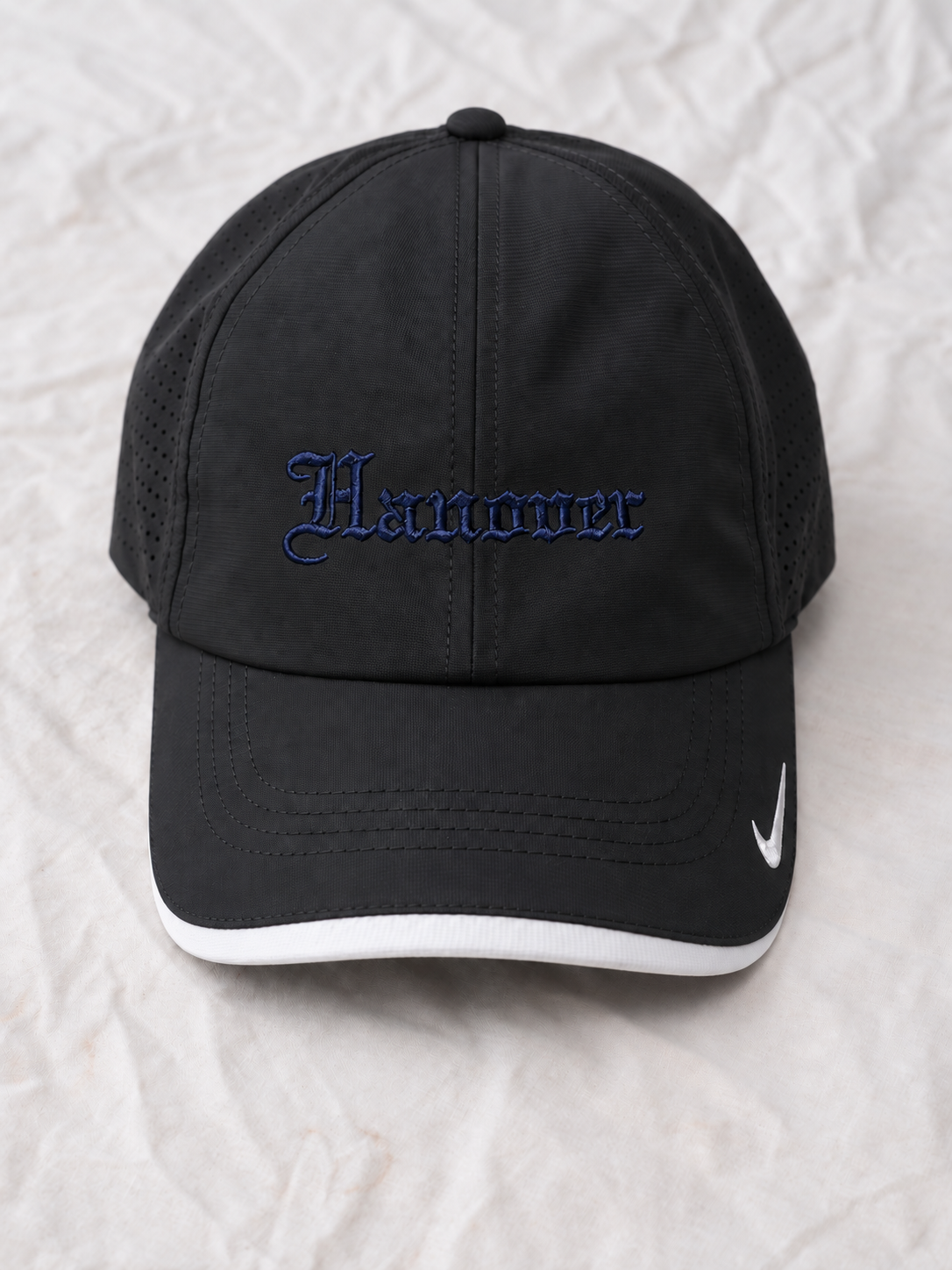 Hanover Blackletter hat in black with blue embroidery on a flat background