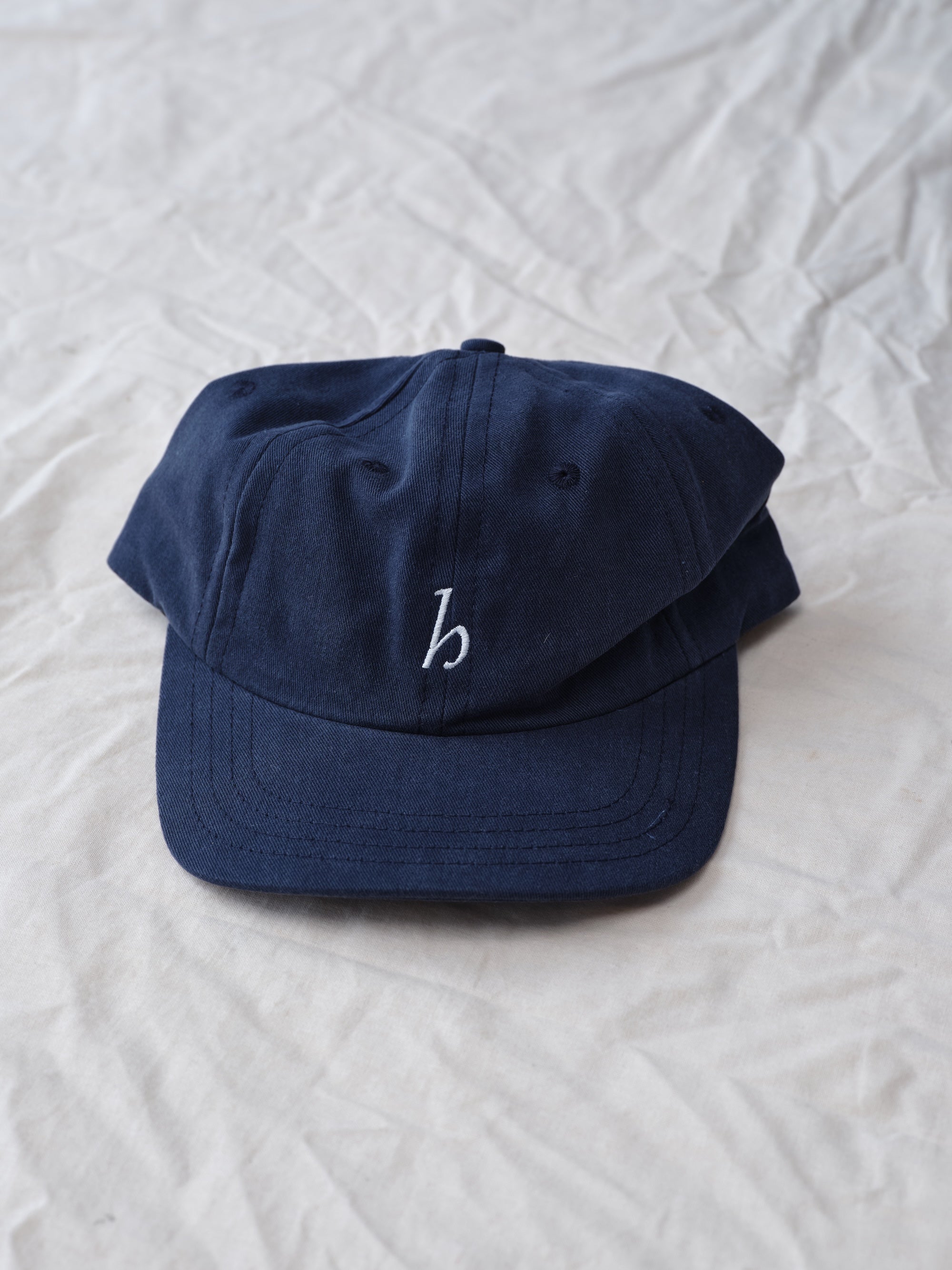 Hanover cap in navy on textured background