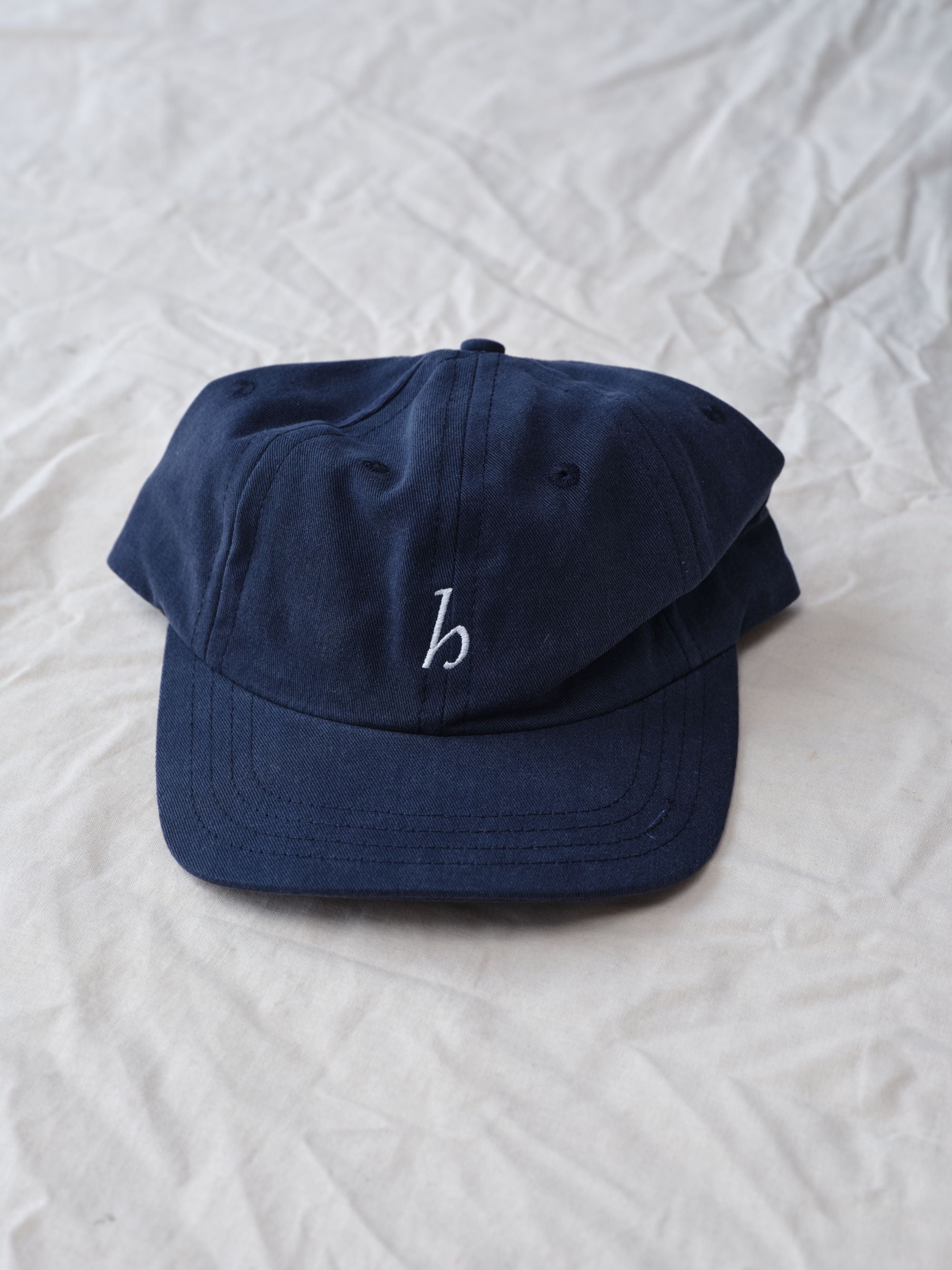 Hanover cap in navy on textured background