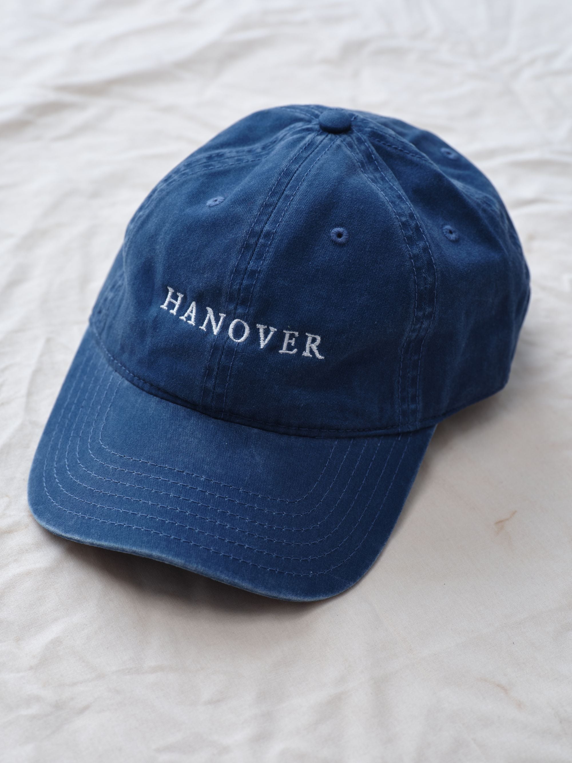 Navy blue cap with 'HANOVER' text on a white background