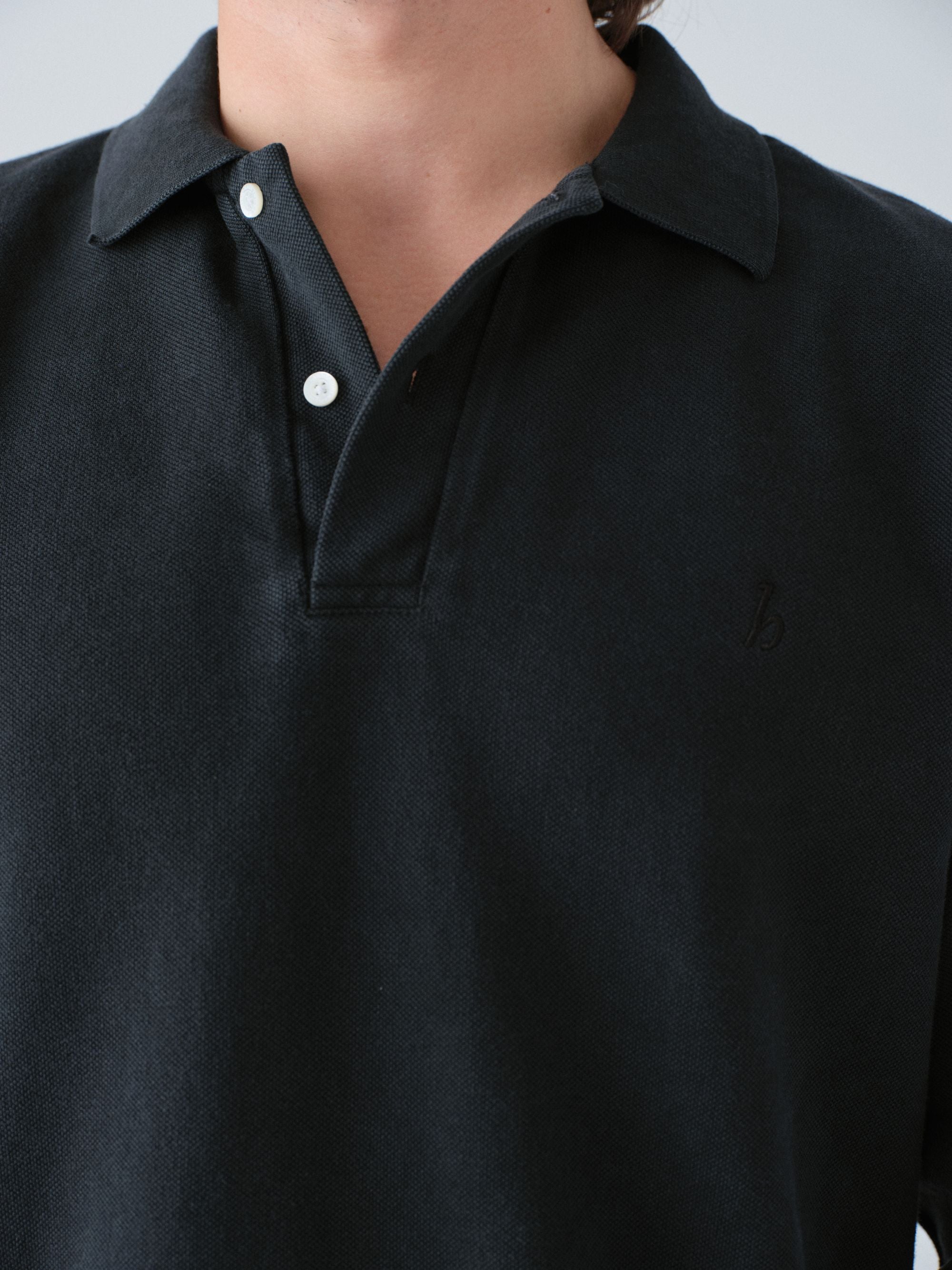 Hanover vintage black polo shirt with white buttons on a plain background