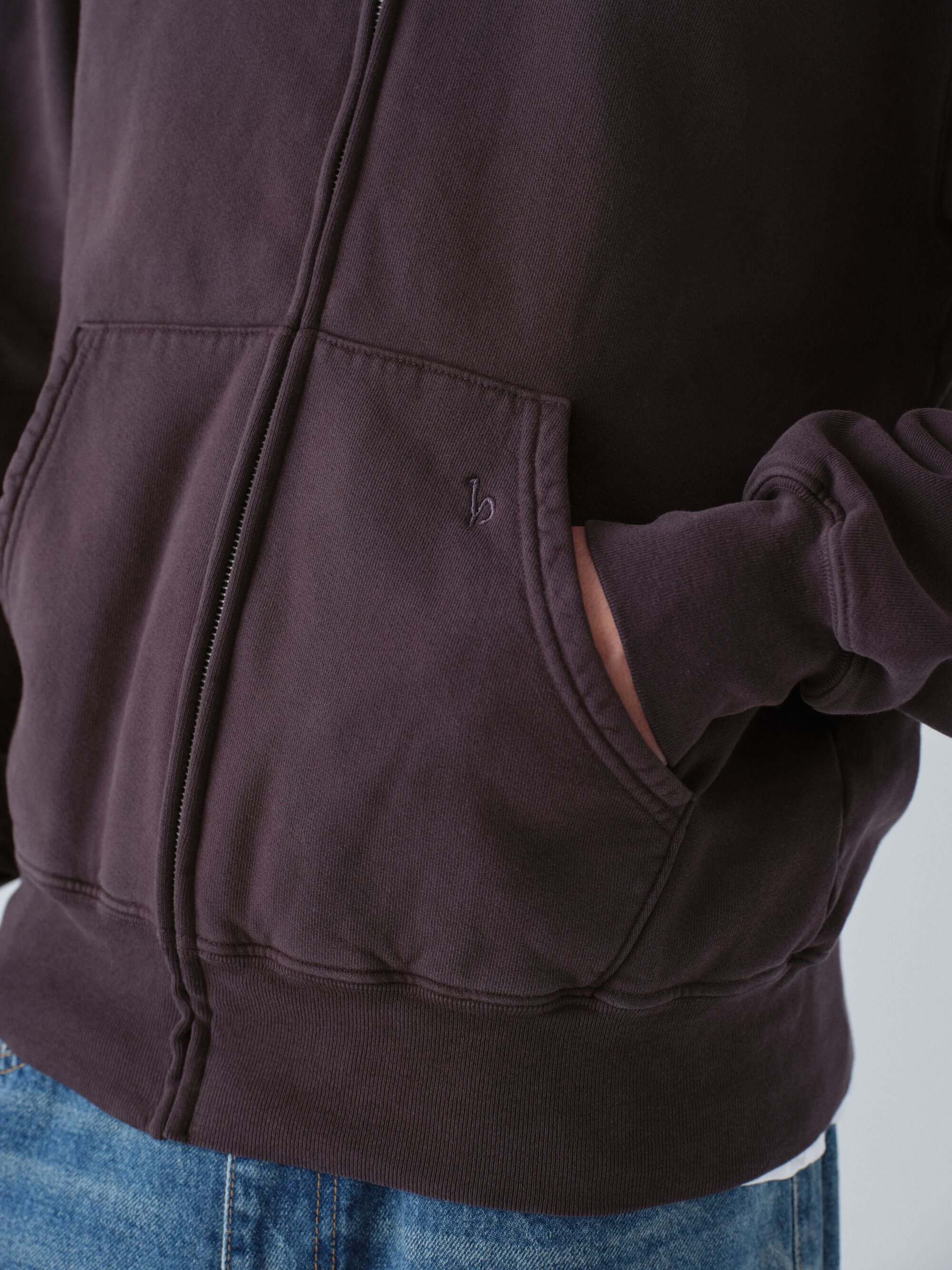 Close-up of a Hanover dark brown zip hoodie with a pocket on a light gray background