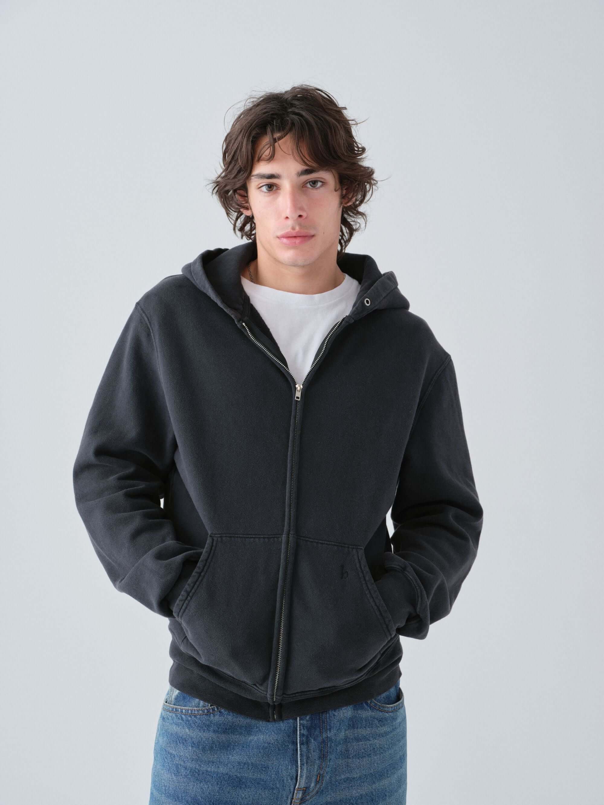 Hanover guy wearing our vintage black zip hoodie with a plain background