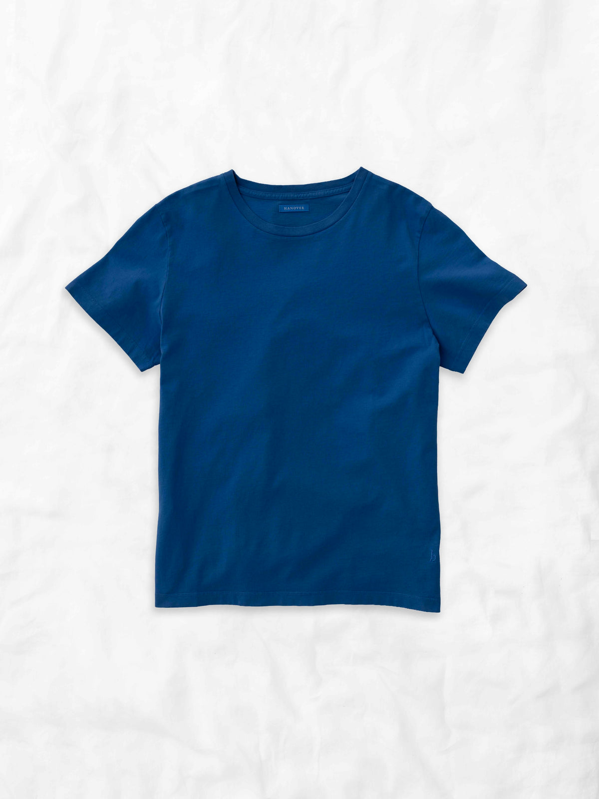 Hanover solid marine blue short-sleeve crewneck t-shirt laid flat on a textured white background.