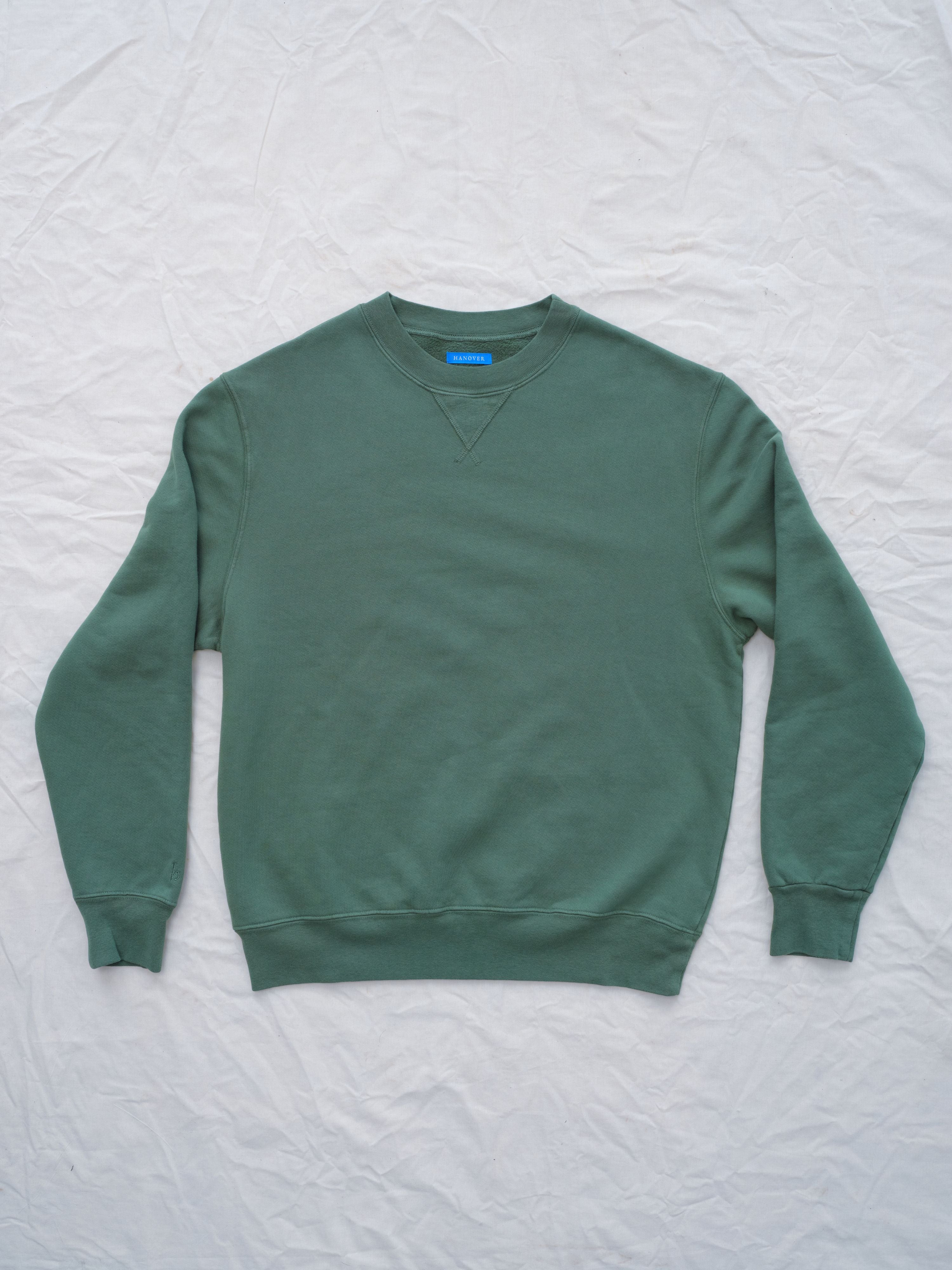 Flat lay of Guy Sunwashed Staple Crewneck in hunter green