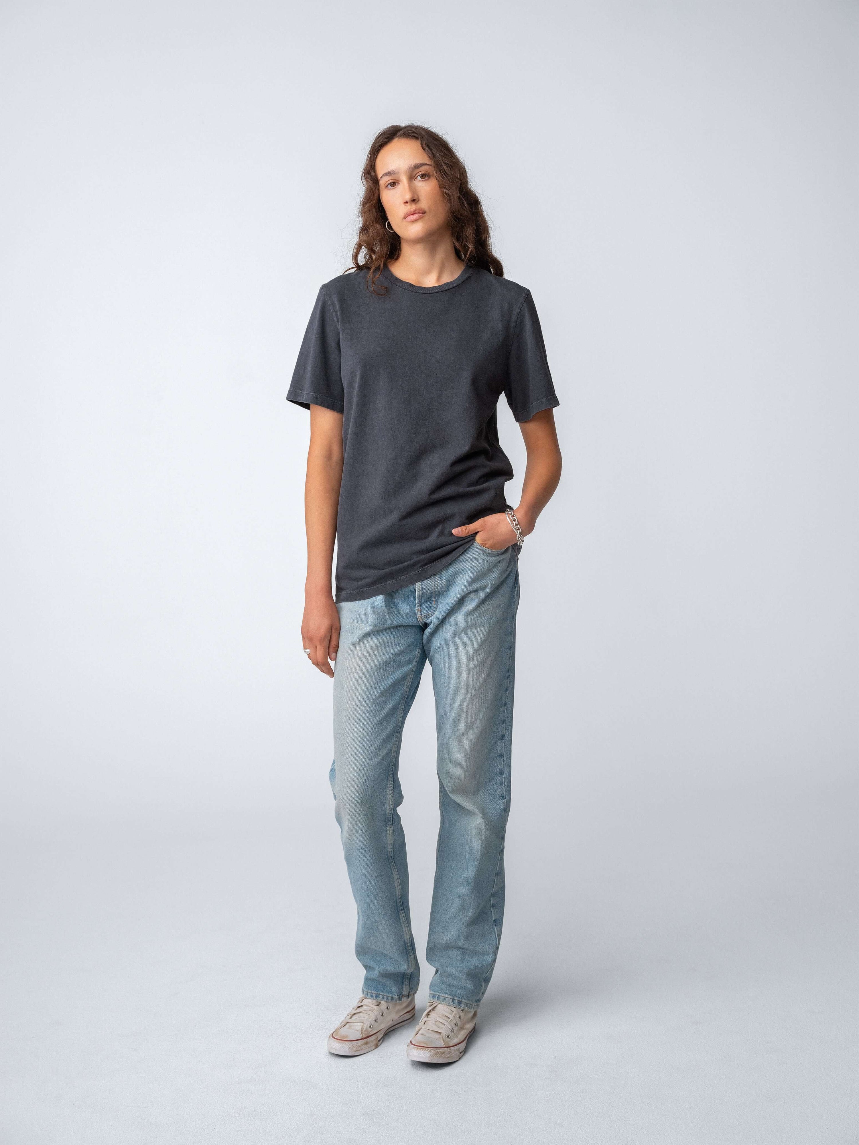 Model wearing Drift Jeans in Washed Blue with a casual t-shirt, showcasing a stylish look.