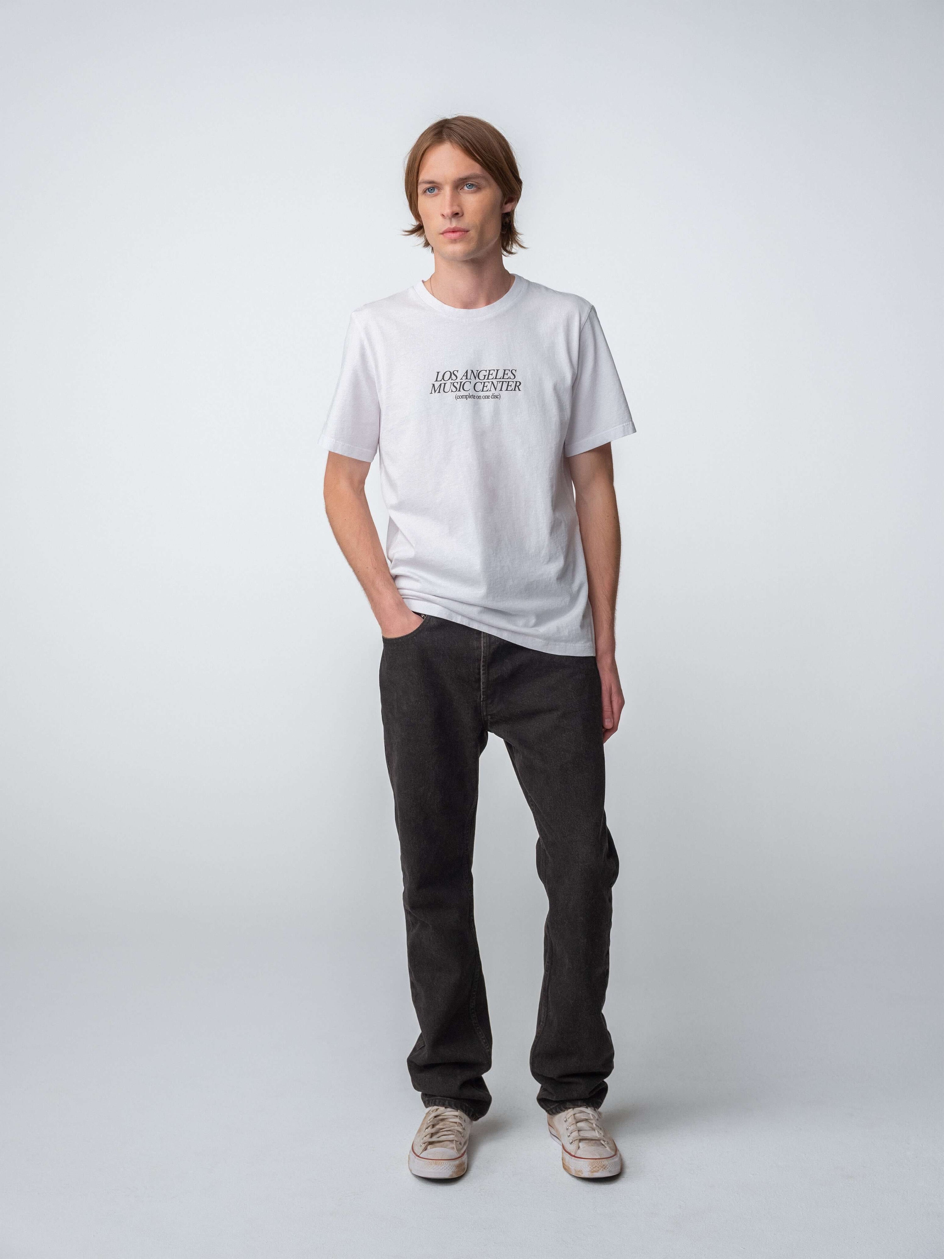 Drift Jeans worn with a white t-shirt, showcasing Washed Black jeans for a casual style.