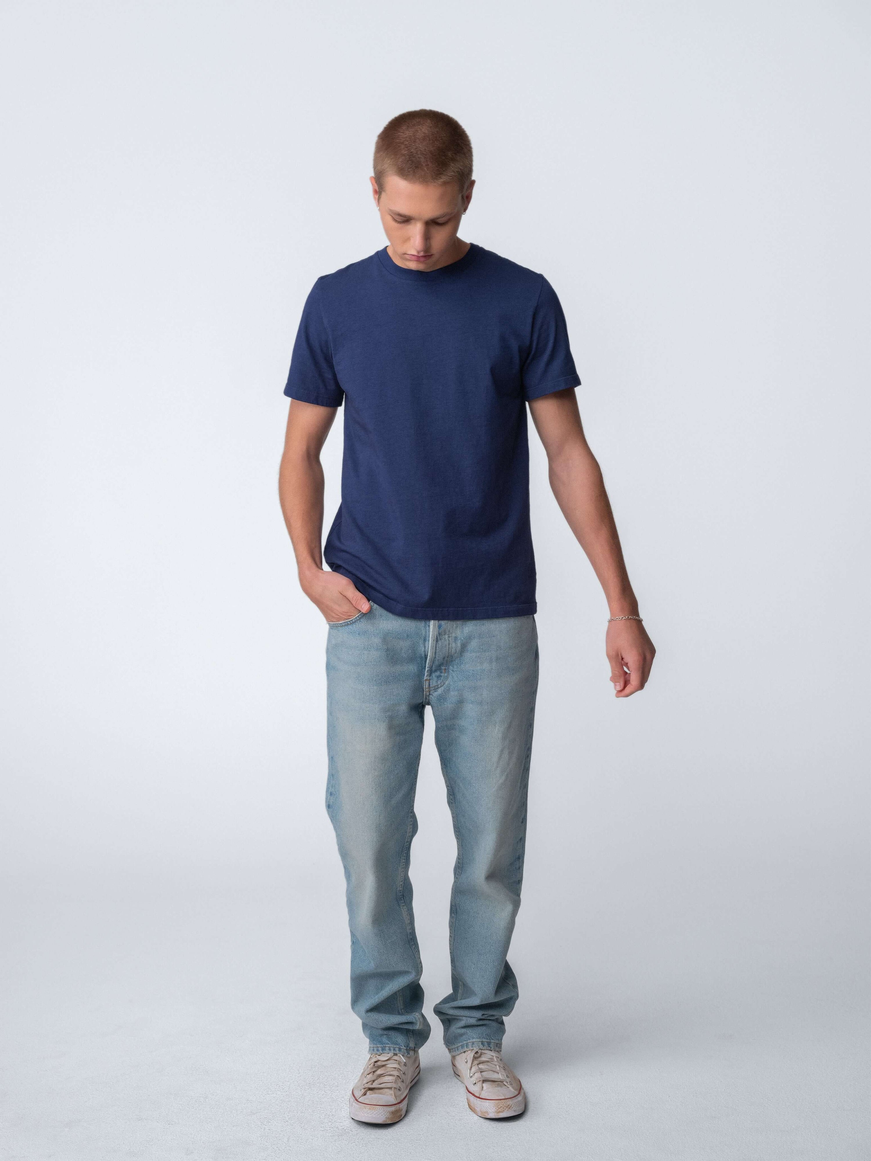 Drift Jeans in Washed Blue worn by a model with a navy t-shirt, showcasing comfortable straight-fit denim style.