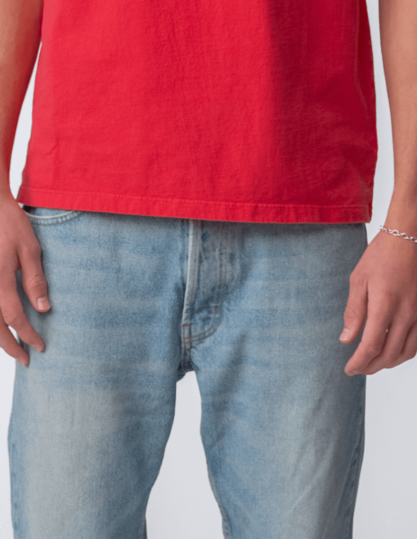 Drift Jeans in Washed Blue, paired with a red shirt, showcasing a classic straight-fit design.