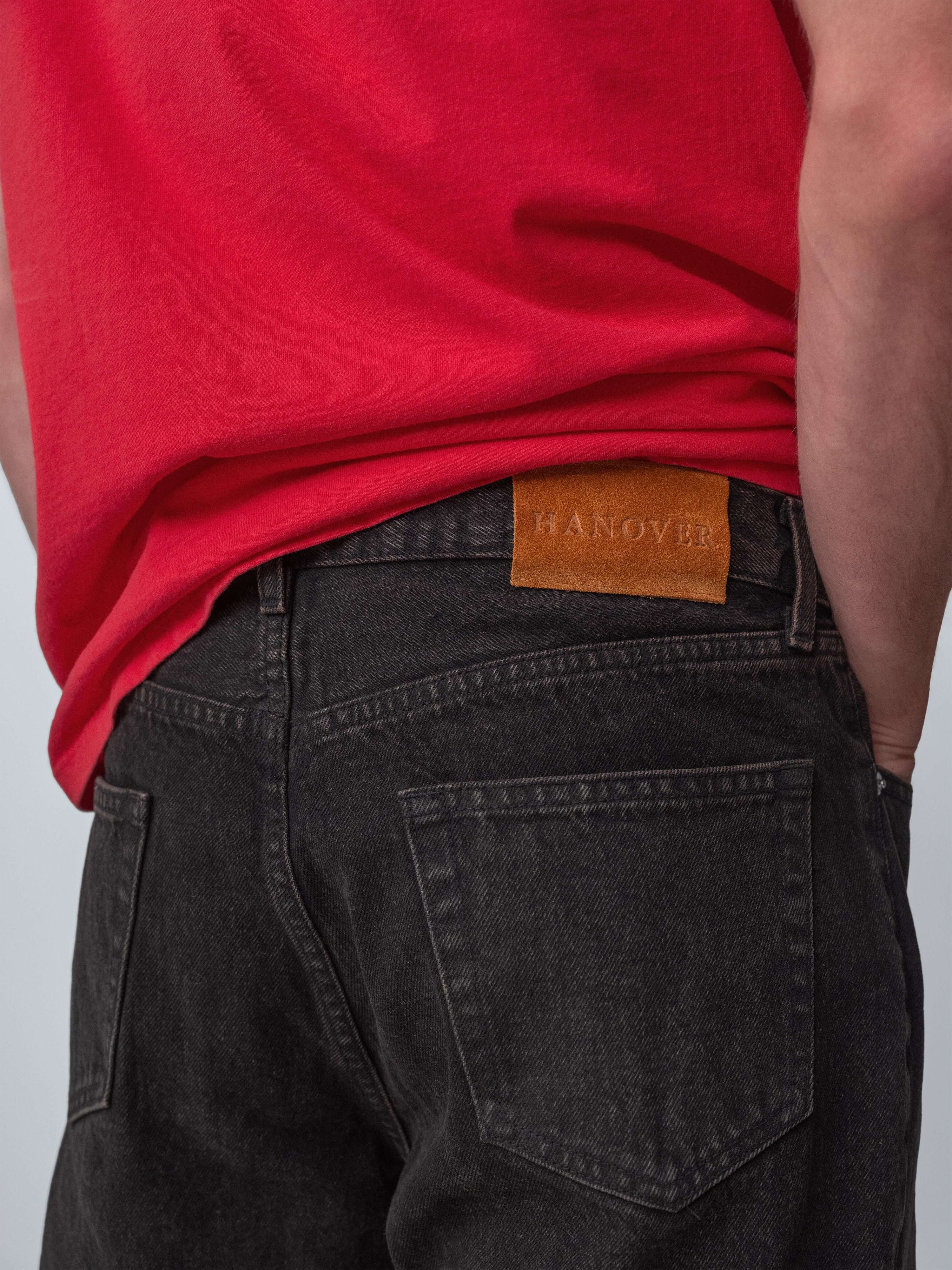 Drift Jeans displayed from the back, featuring Hanover Raw Denim logo on Washed Black jeans, made in USA.